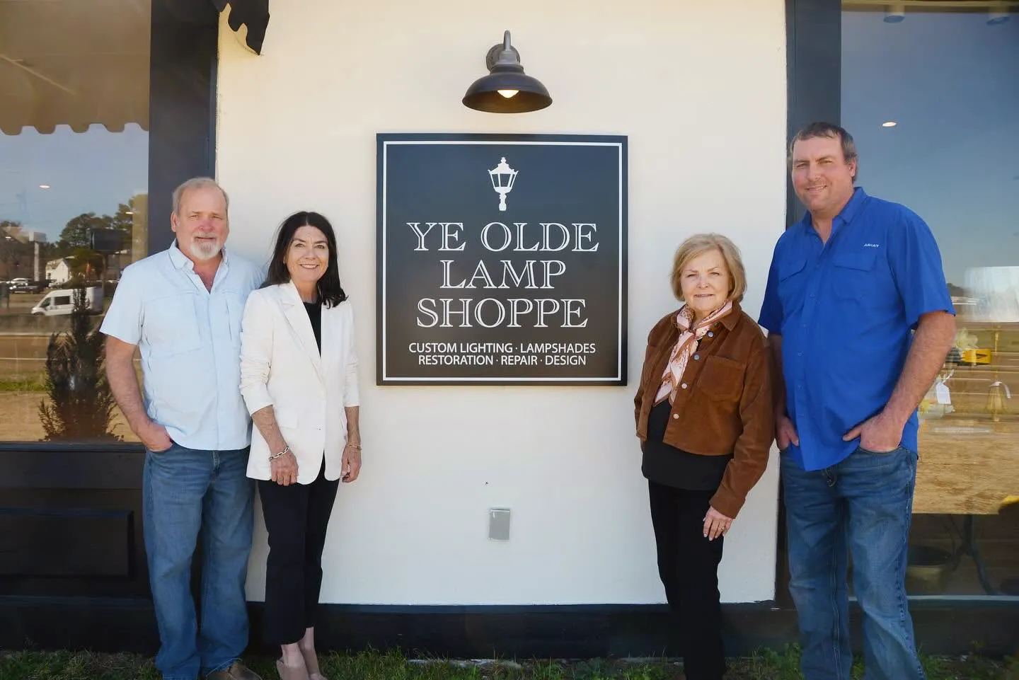 The Ye Olde Lamp Shoppe team gathered outside the shop